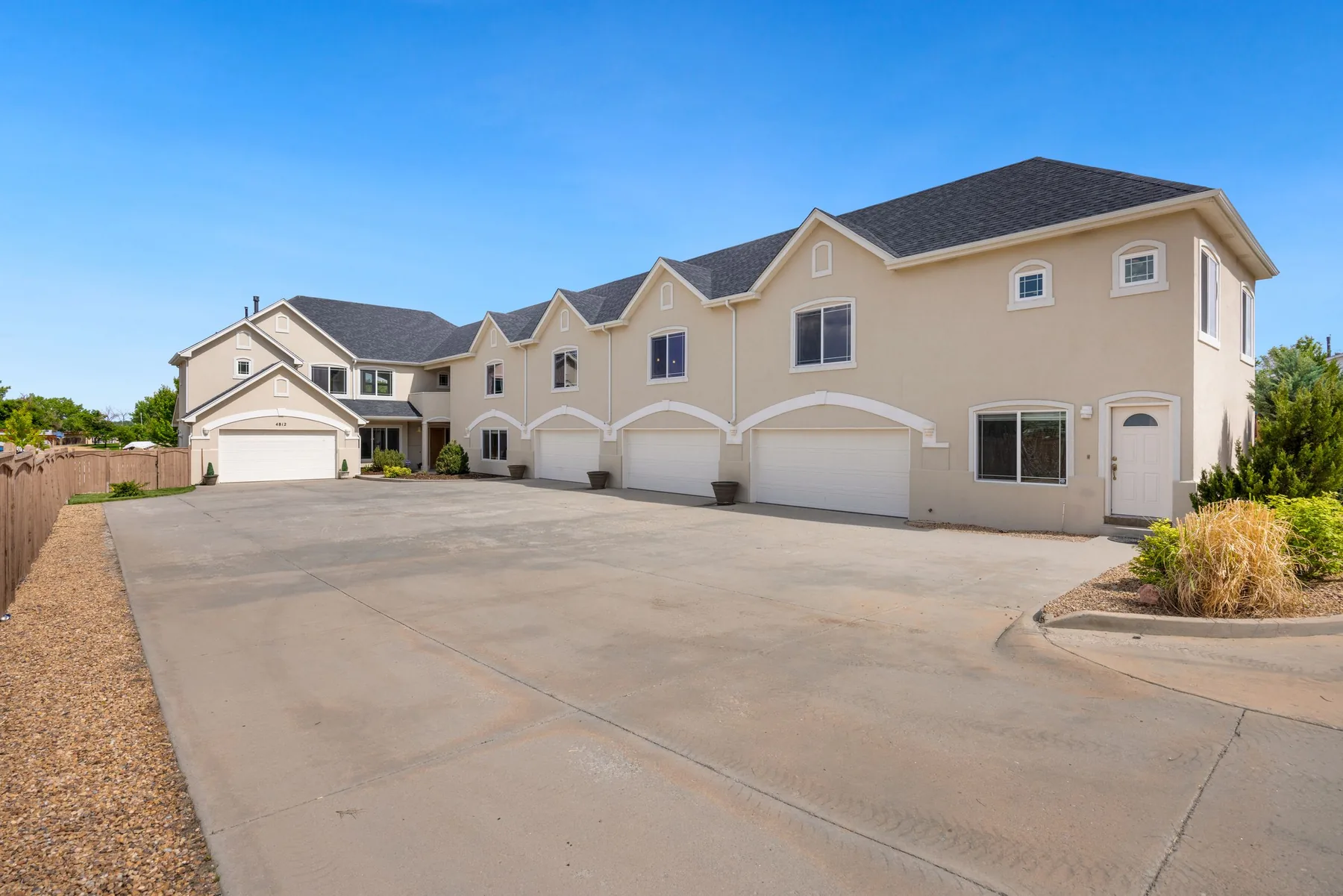 Broad concrete driveway outside a residence; illustrative stock image